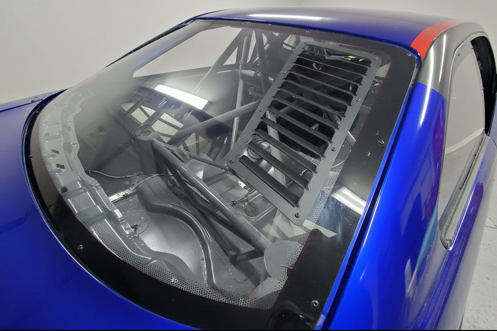 Rear window vents installed in the polycarbonate window of our blue BMW E36