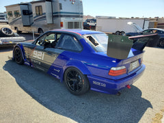 Blue BMW E36 race car with GT3-style rear window vents