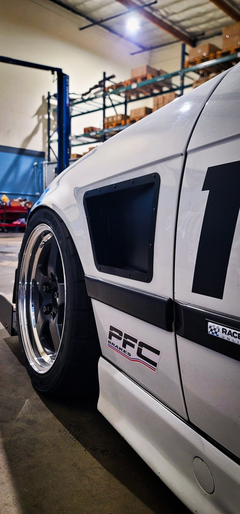 BMW E36 coupe upper fender vents installed on a white race car