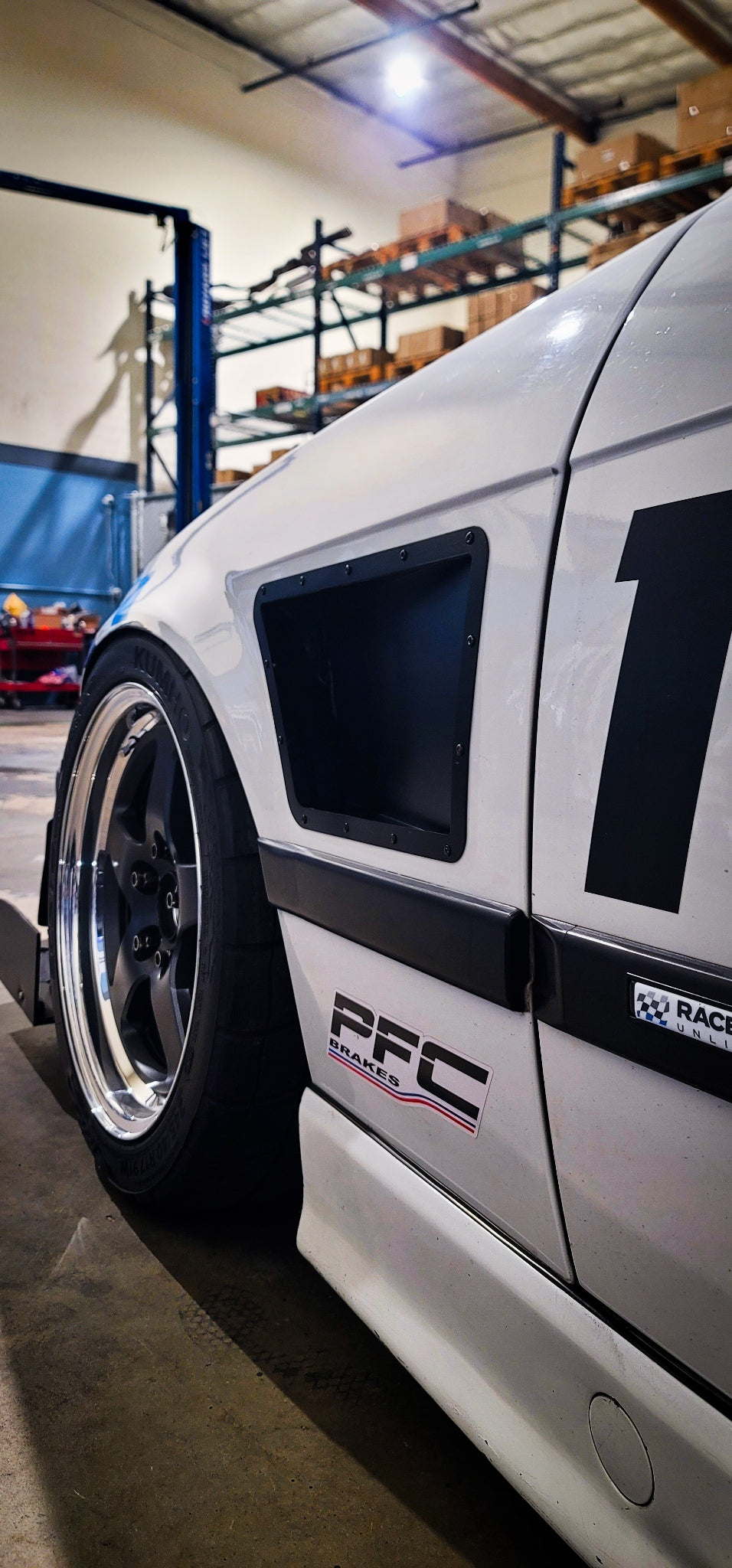 BMW E36 coupe upper fender vents installed on a white race car