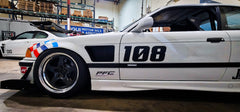 White BMW E36 coupe race car with upper fender vents