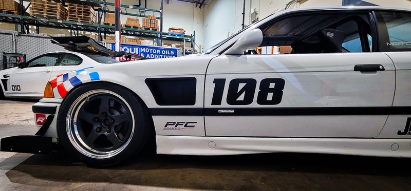 White BMW E36 coupe race car with upper fender vents