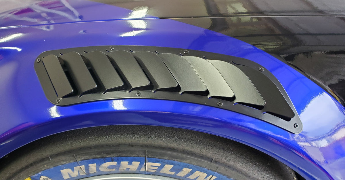Fender vent installed on a front fender arch, close-up