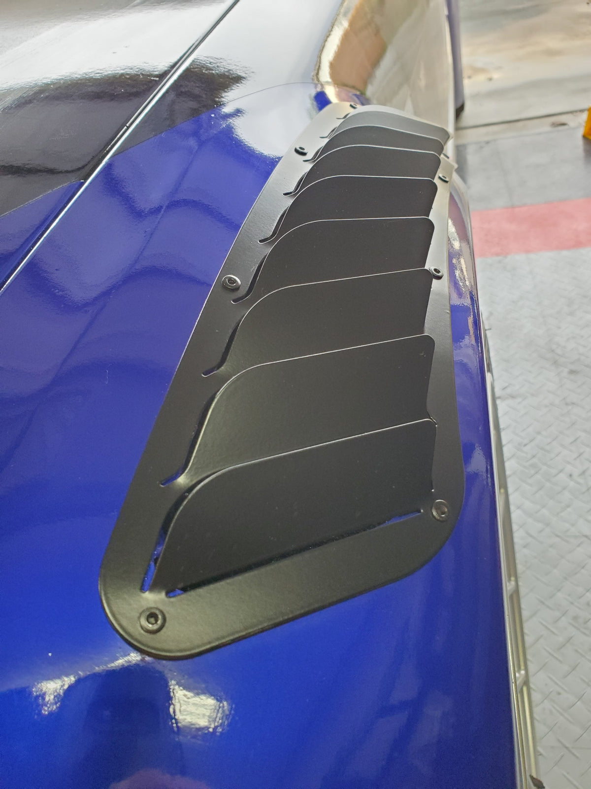 Fender vent riveted on a front fender with fins out
