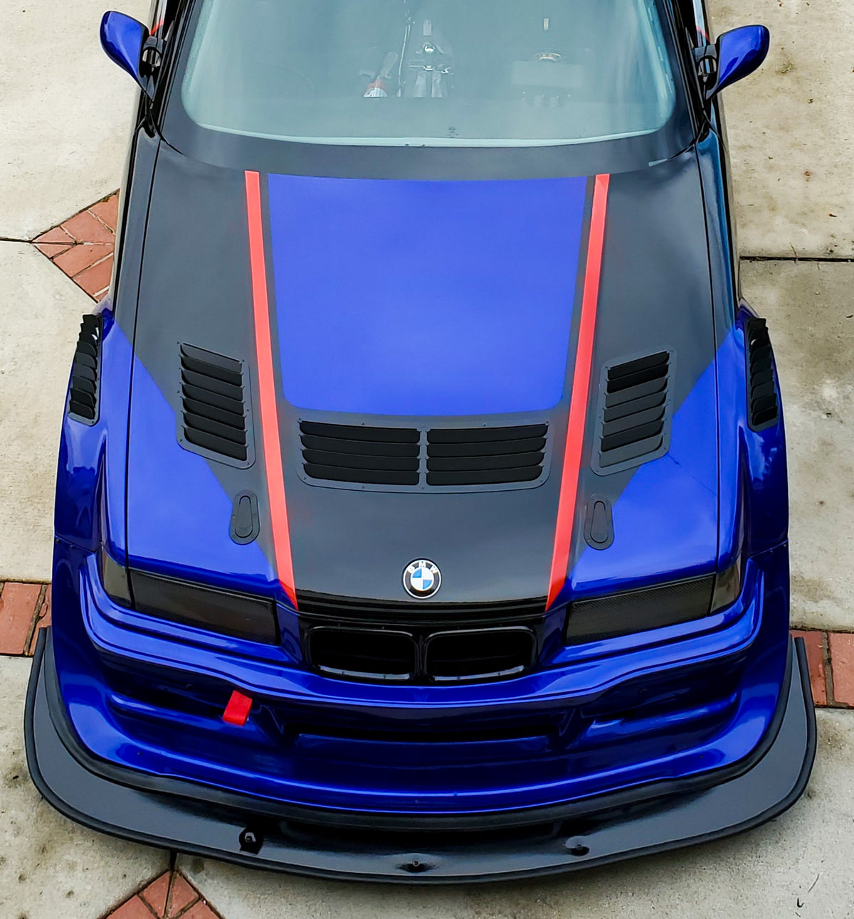 BMW E36 hood vents installed on our blue E36 race car, front view