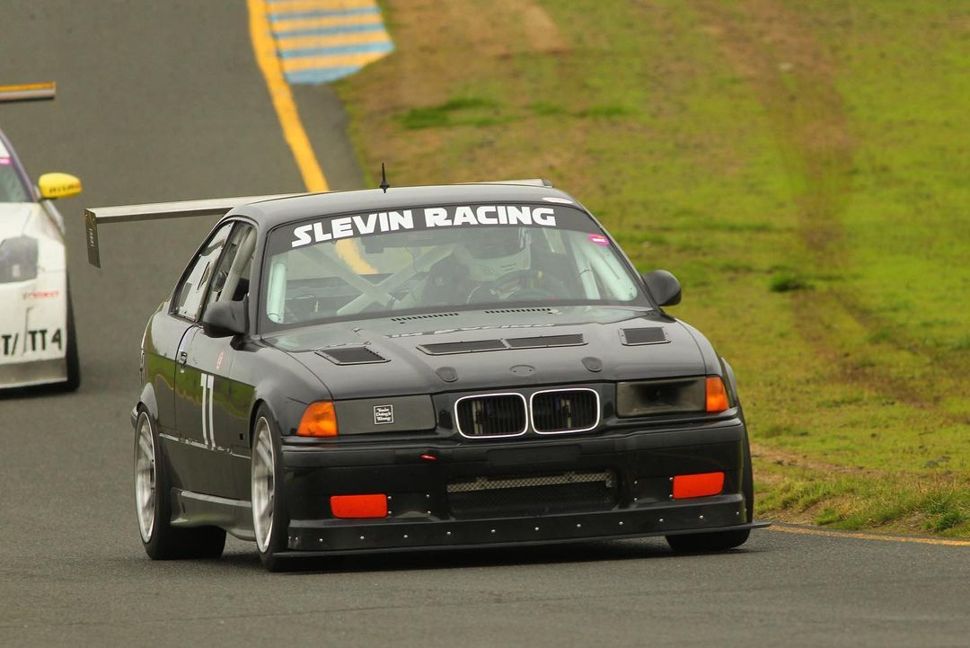 Black BMW E36 with hood vents on track