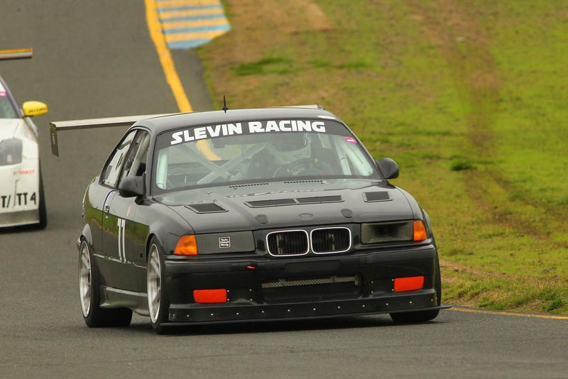 Black BMW E36 with hood vents on track