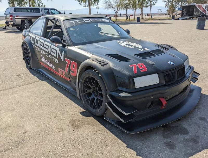 BMW E36 hood vents installed on a black E36 track car